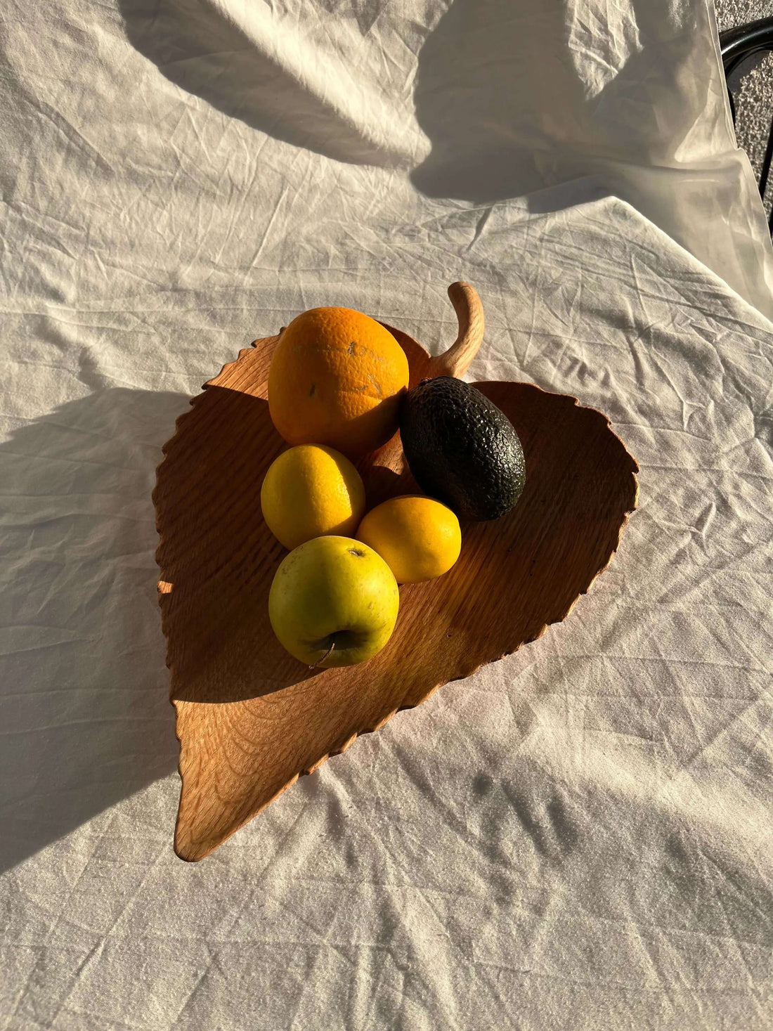 Wooden leaf shaped tray with fruit 